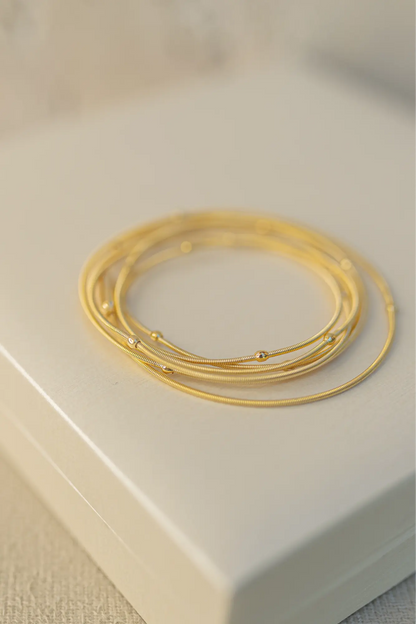 Pulseira Corda de Violão Bolinhas Dourado